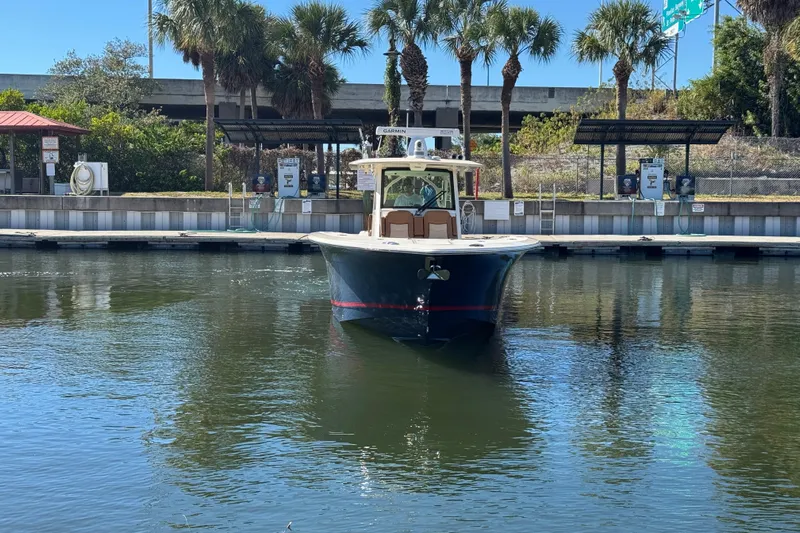  Yacht Photos Pics 2019 Scout 355 LXF boat docked near palm trees and marina.