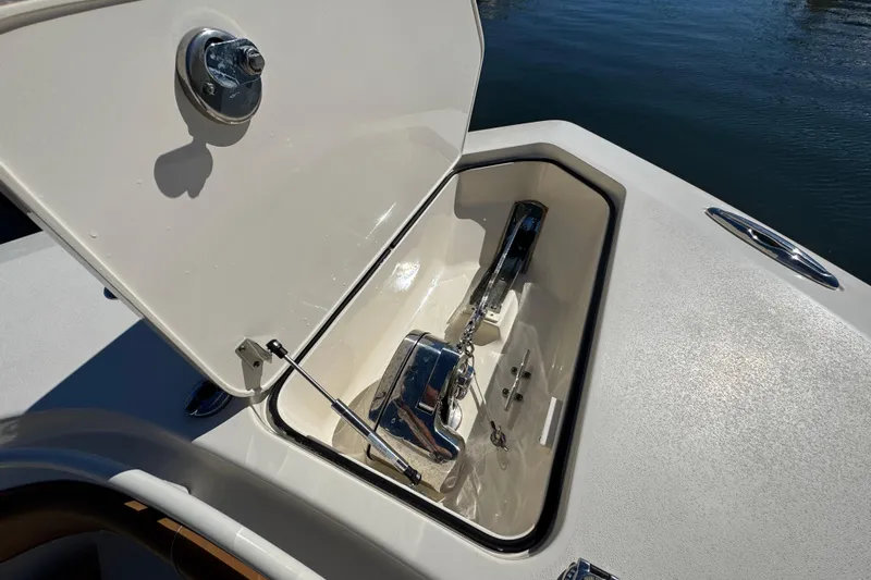  Yacht Photos Pics Open anchor compartment on 2019 Scout 355 LXF boat, showing polished metal anchor.