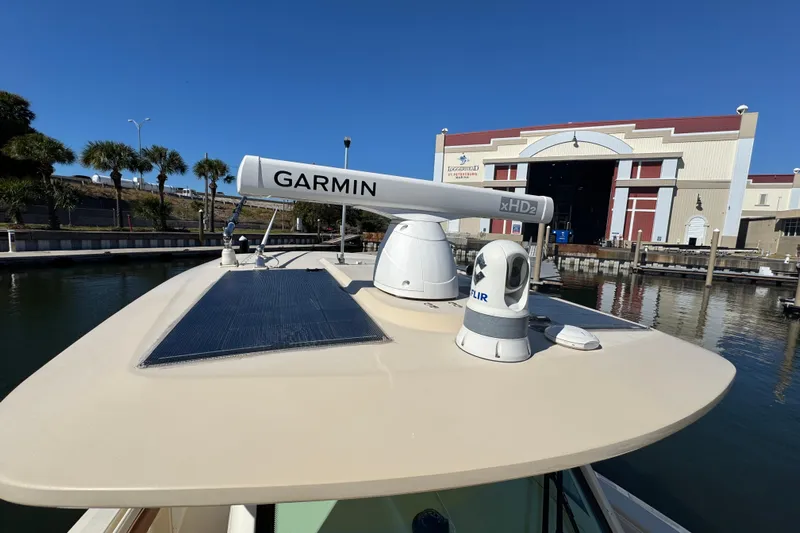 Yacht Photos Pics 2019 Scout 355 LXF boat with Garmin radar and FLIR camera docked near a marina.