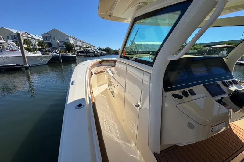  Yacht Photos Pics 2019 Scout 355 LXF boat docked in a marina under clear blue skies.