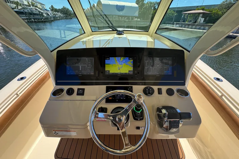  Yacht Photos Pics 2019 Scout 355 LXF boat dashboard with navigation screens and steering wheel.