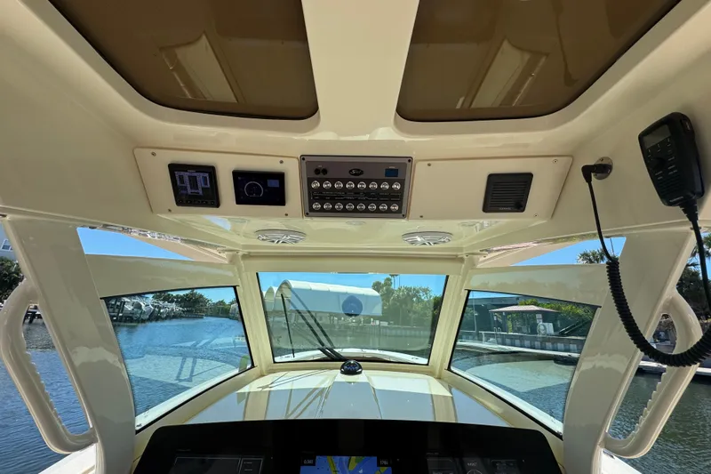  Yacht Photos Pics Interior view of 2019 Scout 355 LXF boat cockpit with control panel and navigation system.