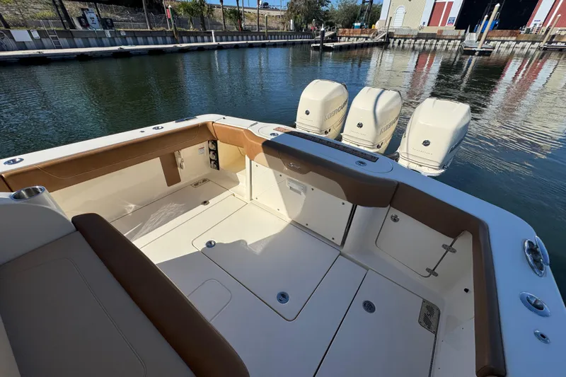  Yacht Photos Pics 2019 Scout 355 LXF boat interior with triple outboard engines at dock.