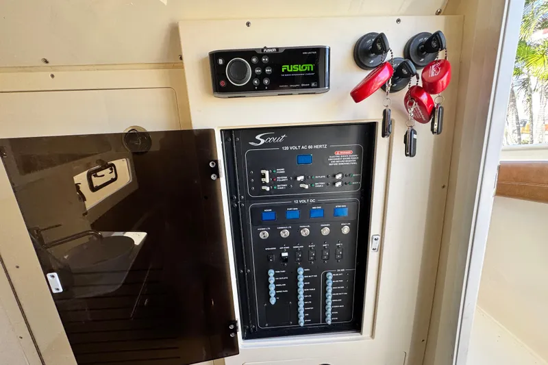  Yacht Photos Pics Control panel of a 2019 Scout 355 LXF boat with keys and audio system.