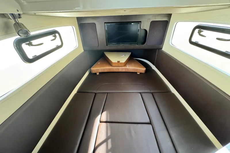  Yacht Photos Pics 2019 Scout 355 LXF cabin interior with brown seating and windows.