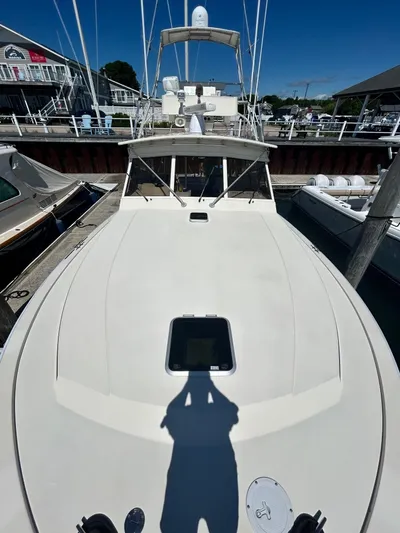 Carolina Girl Yacht Photos Pics 1985 Viking Express boat docked at a marina under clear blue skies.