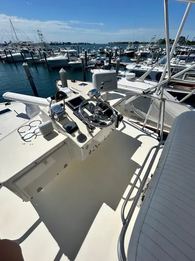 Carolina Girl Yacht Photos Pics 1985 Viking Express boat helm with marina view, featuring steering wheel and controls.
