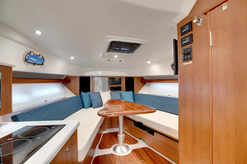  Yacht Photos Pics Manufacturer Provided Image: 2025 Pursuit OS 355 Offshore cabin interior with modern seating and wooden finishes.