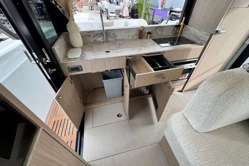  Yacht Photos Pics Modern kitchen interior of 2026 Prestige Yachts F4.3, featuring sleek cabinetry and appliances.