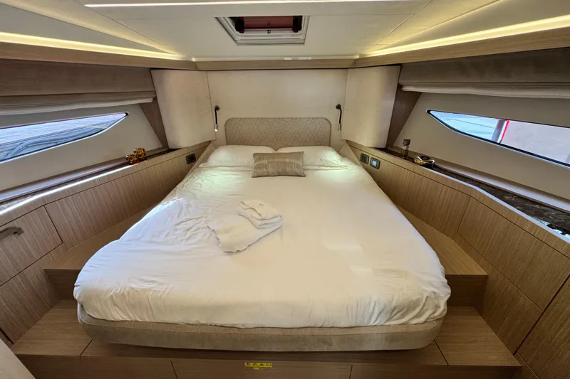  Yacht Photos Pics Luxurious bedroom interior of 2026 Prestige Yachts F4.3, featuring elegant wood finishes and modern design.