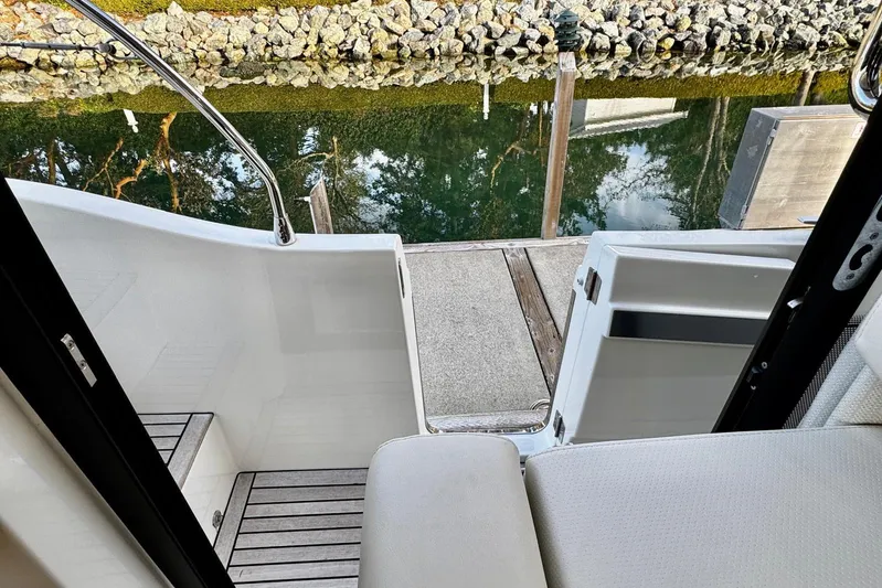 Changes In Latitude Yacht Photos Pics Beneteau Swift Trawler 41 Fly 2022, open door to dock, serene water view.