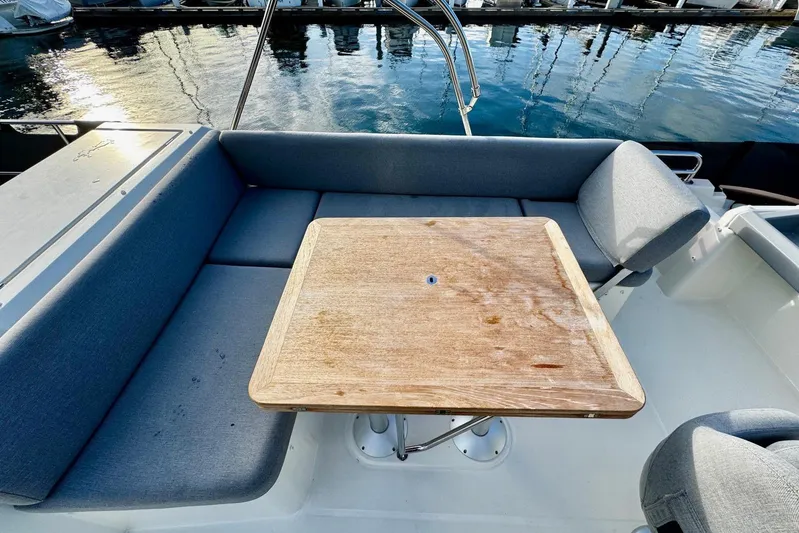 Changes In Latitude Yacht Photos Pics 2022 Beneteau Swift Trawler 41 Fly, outdoor seating area with wooden table.