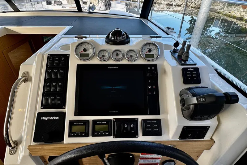 Changes In Latitude Yacht Photos Pics Control panel of 2022 Beneteau Swift Trawler 41 Fly with Raymarine navigation system.