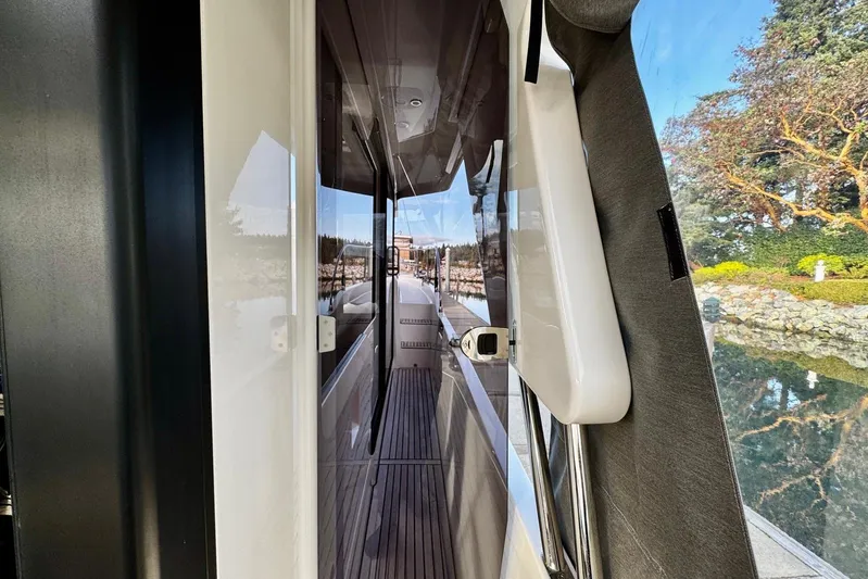 Changes In Latitude Yacht Photos Pics 2022 Beneteau Swift Trawler 41 Fly, side deck view with scenic background.