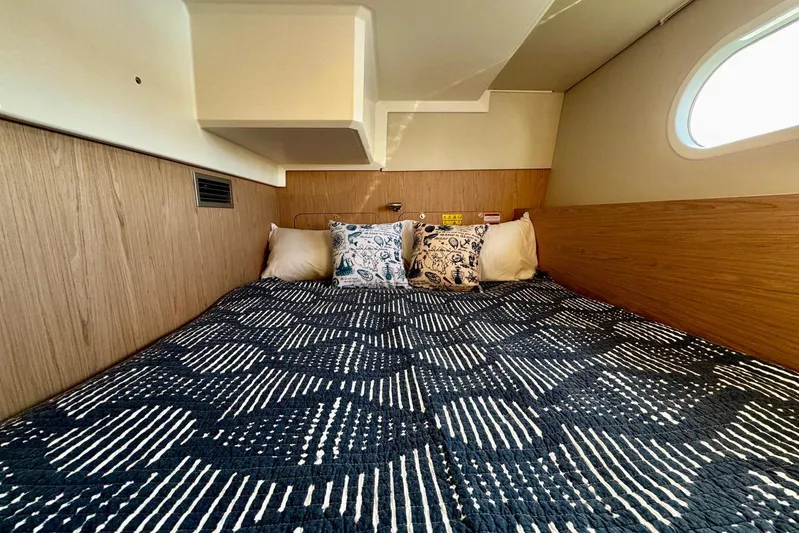 Changes In Latitude Yacht Photos Pics Cozy cabin interior of 2022 Beneteau Swift Trawler 41 Fly with patterned bedding.
