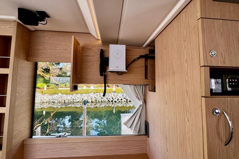 Changes In Latitude Yacht Photos Pics Interior of 2022 Beneteau Swift Trawler 41 Fly with wood finish and window view.