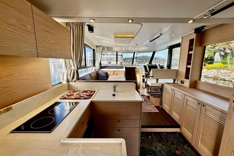 Changes In Latitude Yacht Photos Pics Luxurious interior of 2022 Beneteau Swift Trawler 41 Fly with modern kitchen and seating area.
