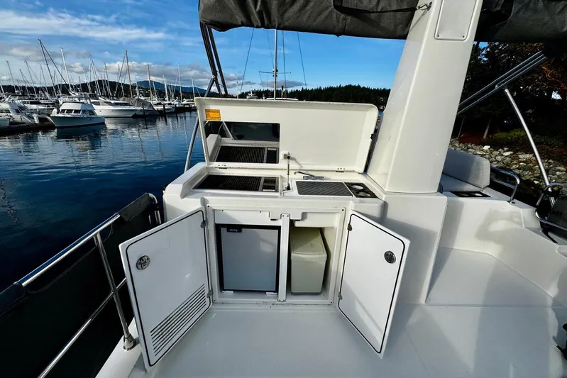 Changes In Latitude Yacht Photos Pics 2022 Beneteau Swift Trawler 41 Fly, outdoor kitchenette with storage, docked at marina.