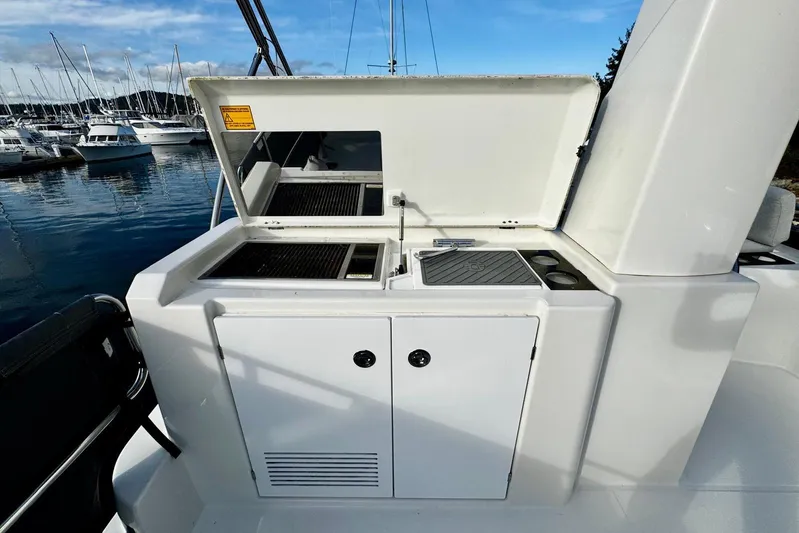 Changes In Latitude Yacht Photos Pics Outdoor kitchen on 2022 Beneteau Swift Trawler 41 Fly, featuring grill and sink.