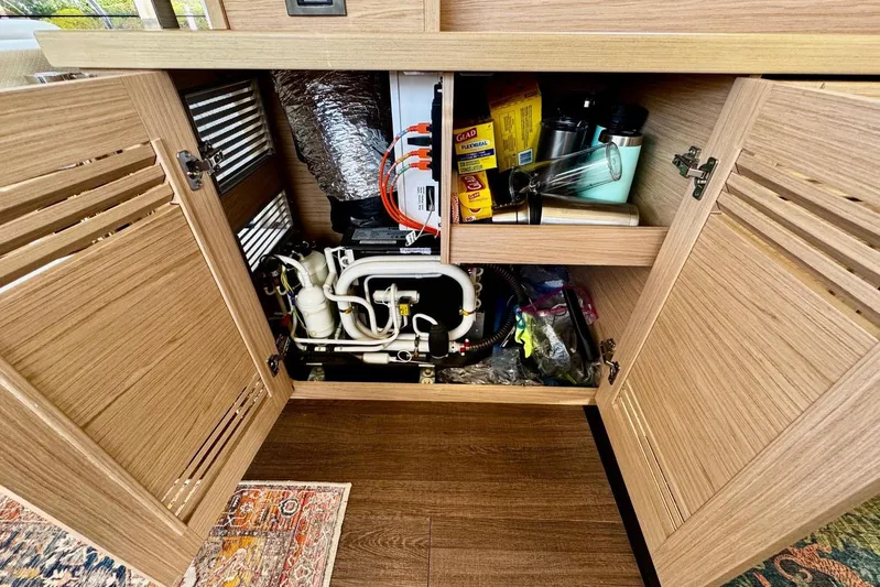 Changes In Latitude Yacht Photos Pics Interior storage of 2022 Beneteau Swift Trawler 41 Fly, showcasing organized compartments and equipment.