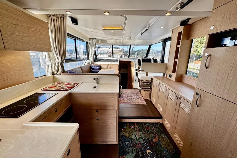 Changes In Latitude Yacht Photos Pics Interior of 2022 Beneteau Swift Trawler 41 Fly, featuring modern kitchen and seating area.