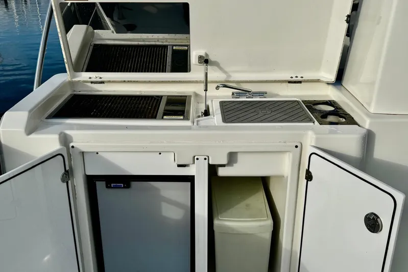 Changes In Latitude Yacht Photos Pics Outdoor kitchen on 2022 Beneteau Swift Trawler 41 Fly with grill and sink.