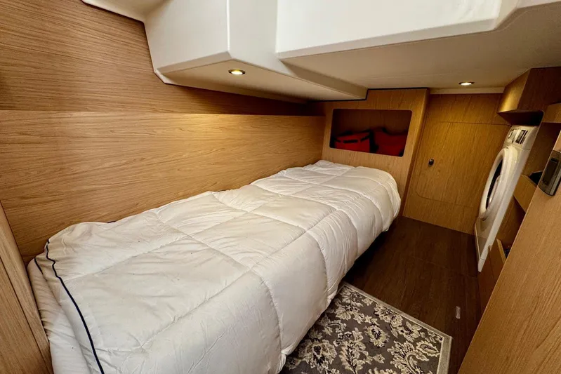 Changes In Latitude Yacht Photos Pics 2022 Beneteau Swift Trawler 41 Fly cabin with bed, wood paneling, and washer.