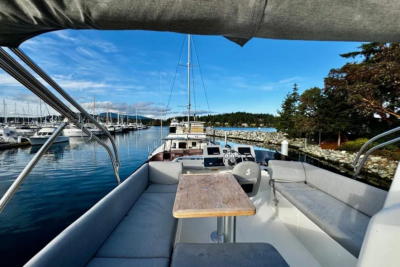 Changes In Latitude Yacht Photos Pics 2022 Beneteau Swift Trawler 41 Fly, docked in scenic marina with clear skies.