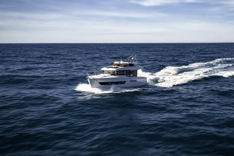  Yacht Photos Pics 2026 Beneteau Swift Trawler 37 cruising on open sea under clear skies.