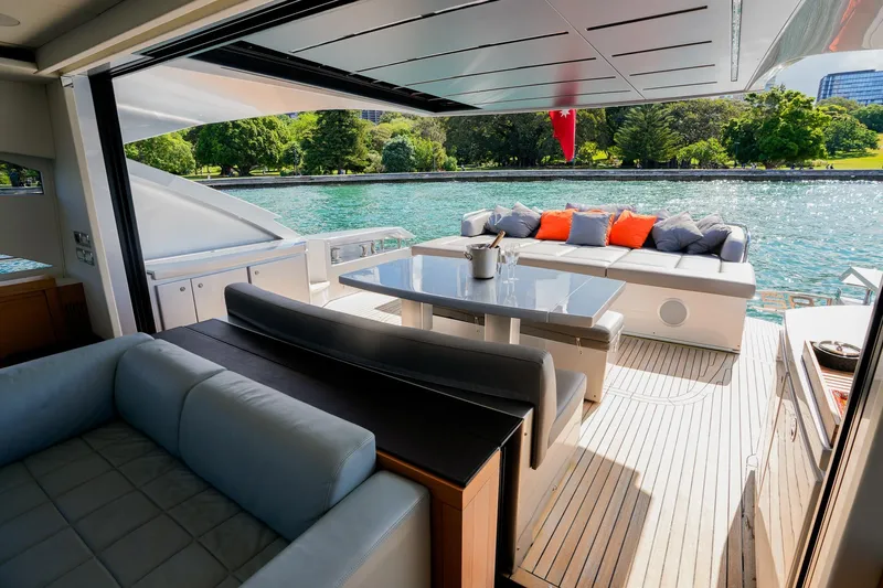 My Veloce Yacht Photos Pics Luxurious 2013 Pershing 82 yacht deck with elegant seating and scenic waterfront view.