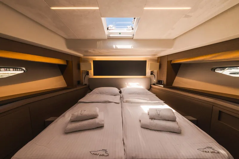  Yacht Photos Pics Luxurious cabin interior of 2022 Prestige 590 yacht with elegant bedding and natural light.