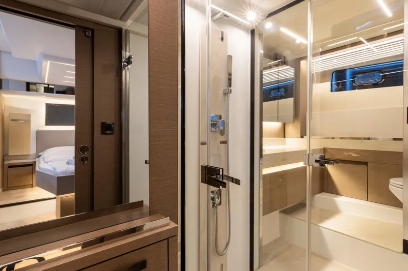  Yacht Photos Pics Luxurious interior of 2022 Prestige 590 yacht featuring modern bathroom and bedroom design.