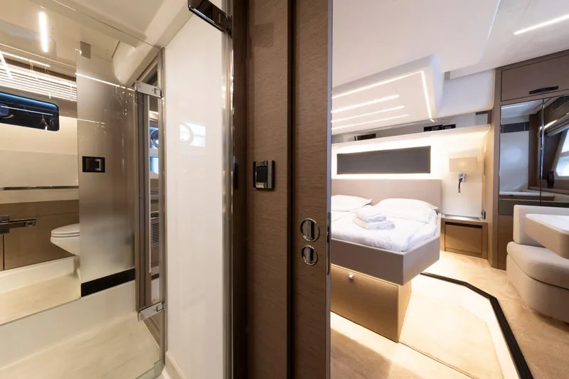  Yacht Photos Pics Luxurious interior of 2022 Prestige 590 yacht featuring a modern bedroom and bathroom.