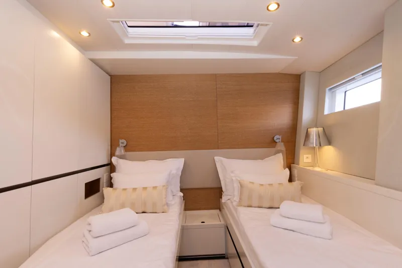  Yacht Photos Pics Luxurious twin cabin interior on 2022 Prestige 590 yacht, featuring elegant bedding and modern lighting.