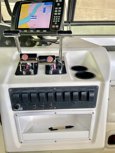 Casting Shadows Yacht Photos Pics Control panel of 1998 Bayliner 3988 Command Bridge Motoryacht with navigation screen and switches.