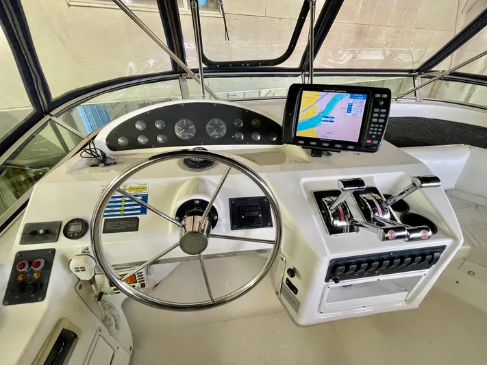 Casting Shadows Yacht Photos Pics 1998 Bayliner 3988 Command Bridge Motoryacht helm with steering wheel and navigation system.