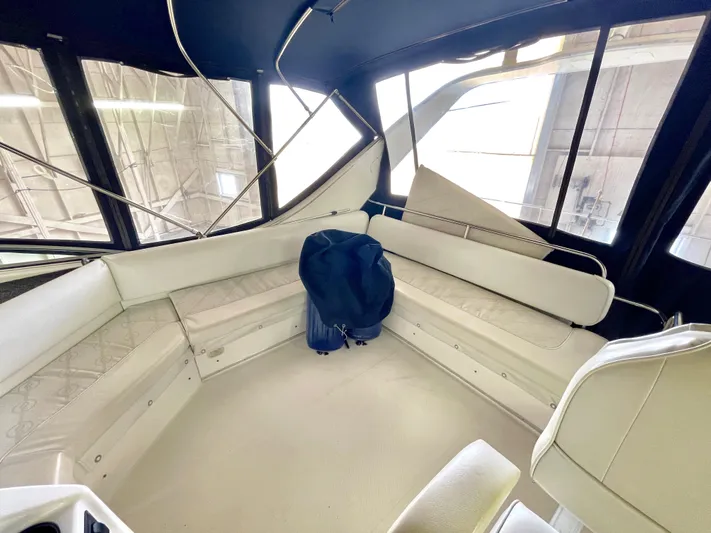 Casting Shadows Yacht Photos Pics 1998 Bayliner 3988 Command Bridge Motoryacht interior with white seating and large windows.