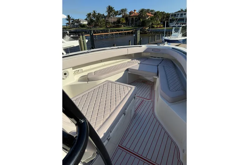 42 - Brokerage Higgins Yacht Photos Pics 2013 Hydra-Sports 42 boat interior with cushioned seating and waterfront view.