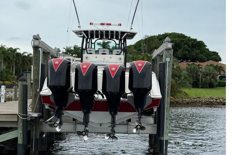 42 - Brokerage Higgins Yacht Photos Pics 2013 Hydra-Sports 42 boat with four powerful outboard engines docked by the water.