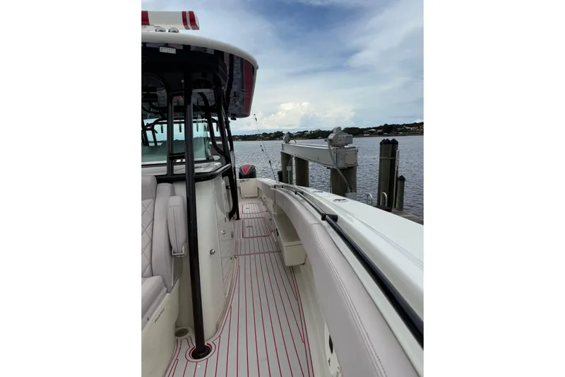 42 - Brokerage Higgins Yacht Photos Pics 2013 Hydra-Sports 42 boat docked, showcasing sleek design and spacious deck.