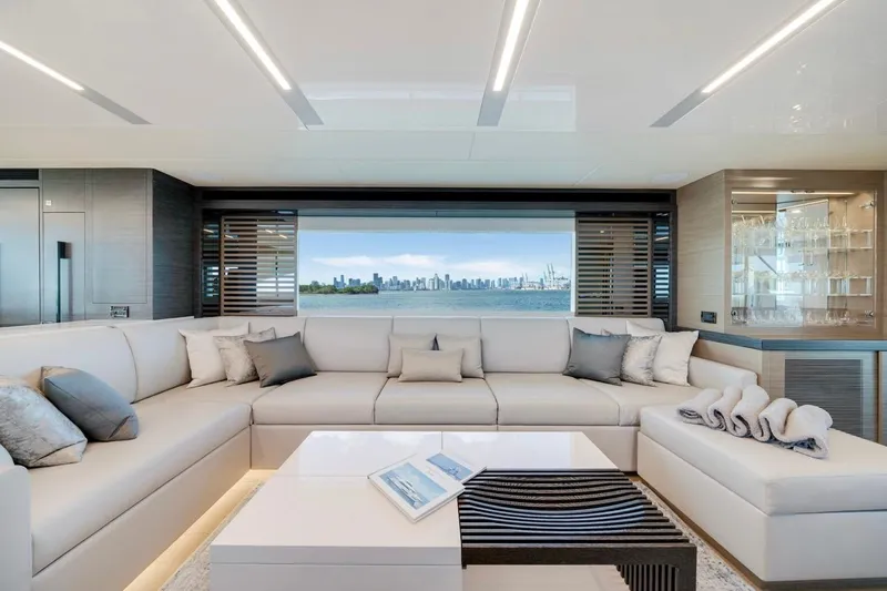 Valiant Yacht Photos Pics Luxurious interior of 2022 Horizon E81 yacht with city skyline view.
