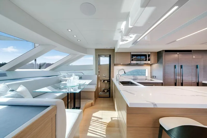 Valiant Yacht Photos Pics Luxurious interior of 2022 Horizon E81 yacht with modern kitchen and dining area.