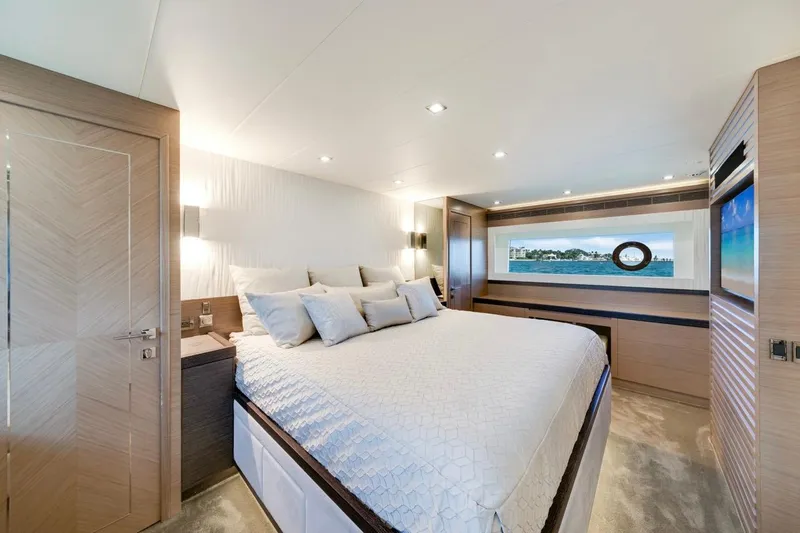 Valiant Yacht Photos Pics Luxurious bedroom interior of 2022 Horizon E81 yacht with ocean view window.