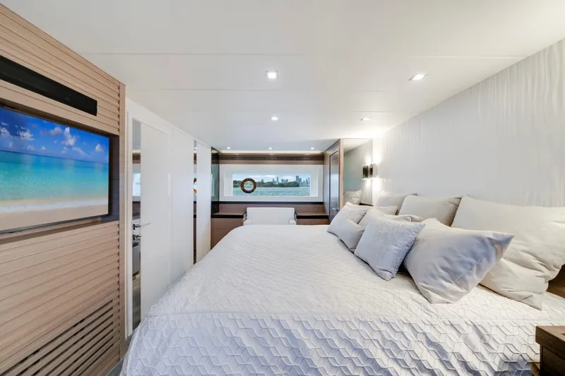 Valiant Yacht Photos Pics Luxurious bedroom interior of 2022 Horizon E81 yacht with modern decor and scenic window view.