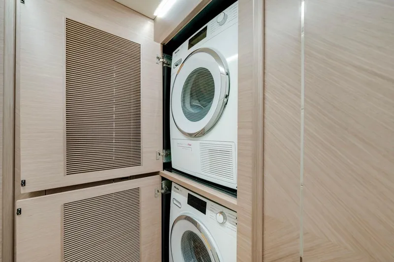 Valiant Yacht Photos Pics Stacked washer and dryer in wooden cabinet, Horizon E81, 2022 model.