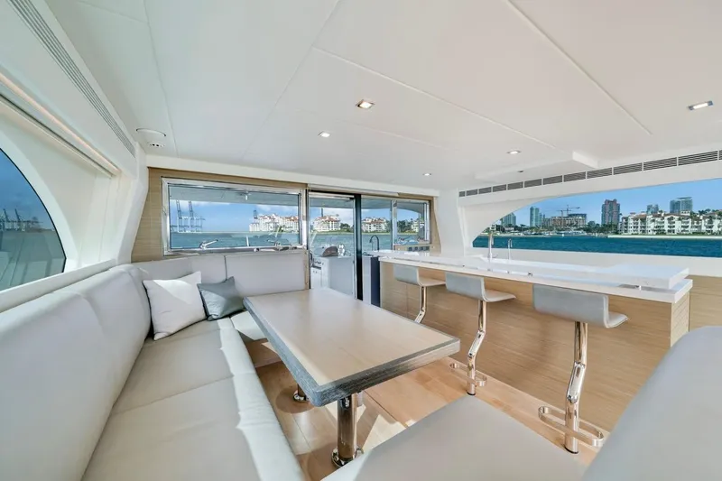 Valiant Yacht Photos Pics Luxurious interior of 2022 Horizon E81 yacht with modern seating and ocean view.