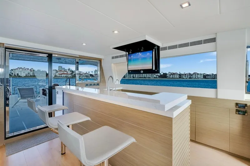 Valiant Yacht Photos Pics Luxurious interior of 2022 Horizon E81 yacht with modern bar and scenic ocean view.