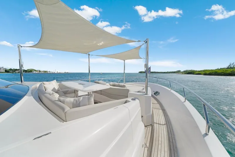 Valiant Yacht Photos Pics Luxurious Horizon E81 yacht deck with seating, sunshade, and ocean view, 2022 model.