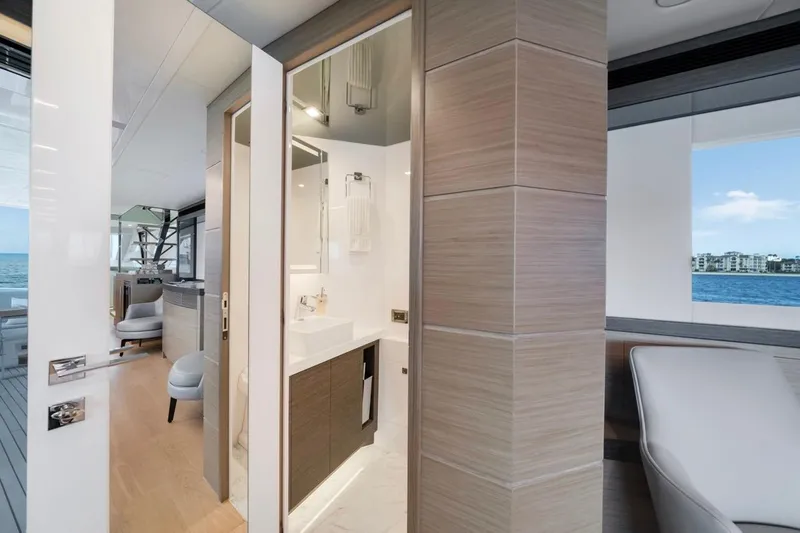 Valiant Yacht Photos Pics Luxurious interior of 2022 Horizon E81 yacht, featuring modern bathroom and ocean view.