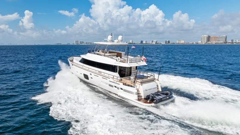  Yacht Photos Pics Azimut Magellano 76 yacht cruising on open sea, 2016 model, under clear blue skies.